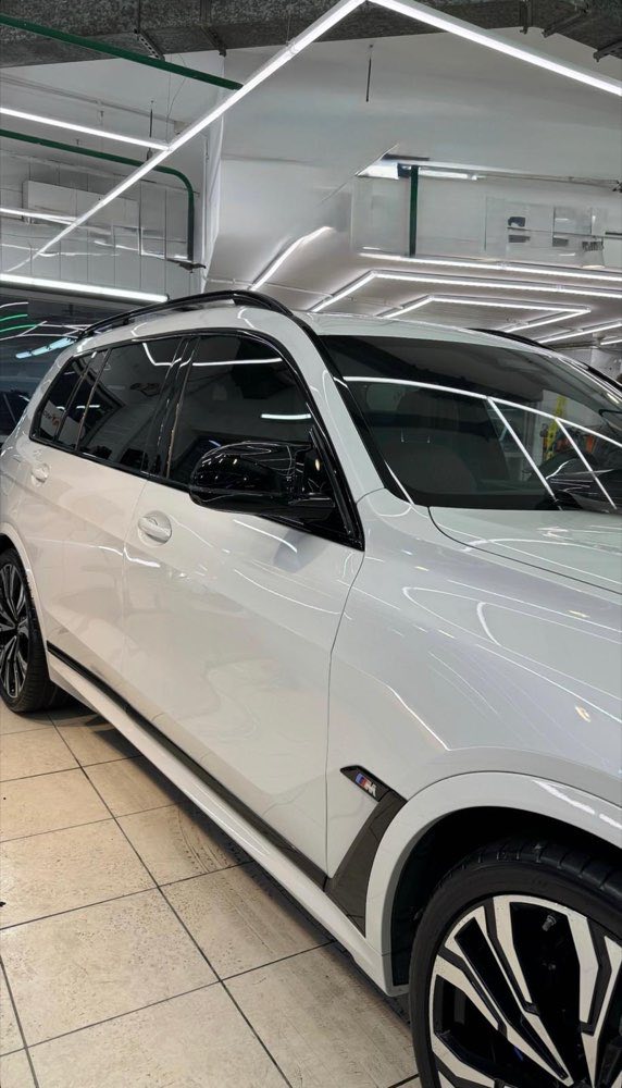 Białe BMW X7 z przyciemnionymi szybami